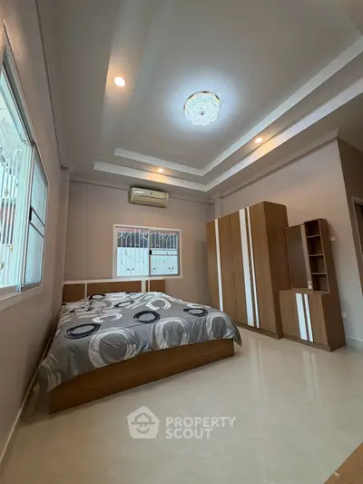 Spacious bedroom with modern design and elegant ceiling light