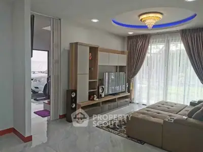 Spacious living room with modern decor and large windows offering natural light