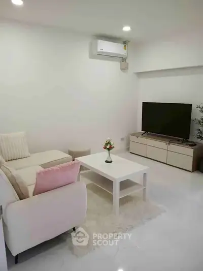 Modern living room with sleek furniture and air conditioning, perfect for relaxation and entertainment.