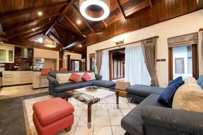 Spacious living room with high wooden ceilings and modern furnishings