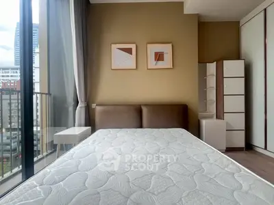 Modern bedroom with large window and stylish decor in urban apartment