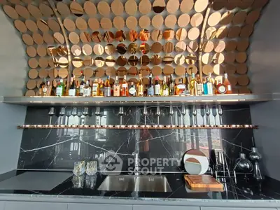 Luxurious home bar with elegant marble countertop and stylish mirrored backsplash