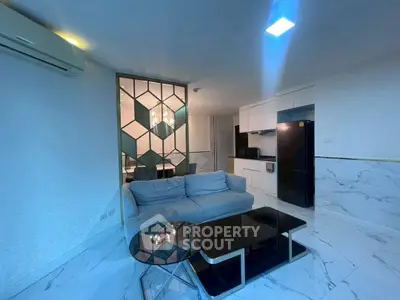 Modern living room with sleek kitchen and stylish decor