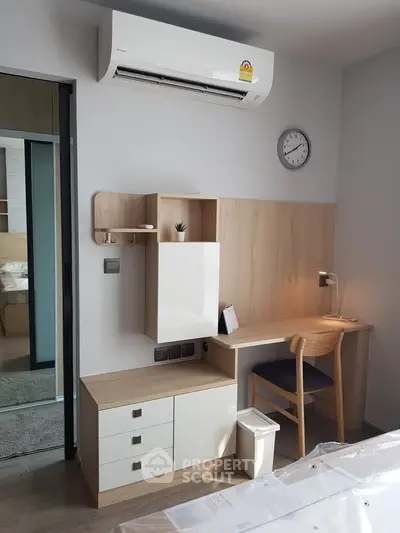 Modern study area with desk, chair, and air conditioning in stylish apartment.