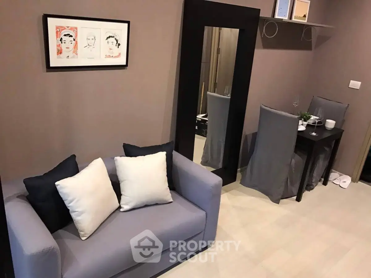 Cozy living room with modern decor and dining area in stylish apartment.