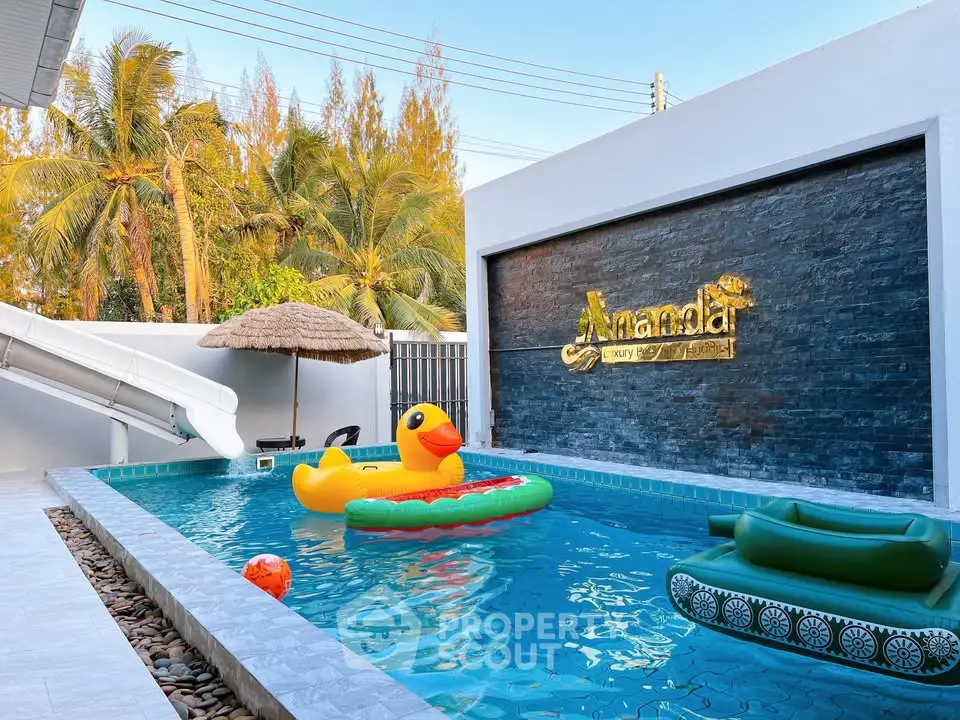 Luxurious private pool with tropical vibes and playful inflatables.