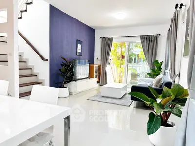 Modern living room with sleek design, large windows, and stylish decor.