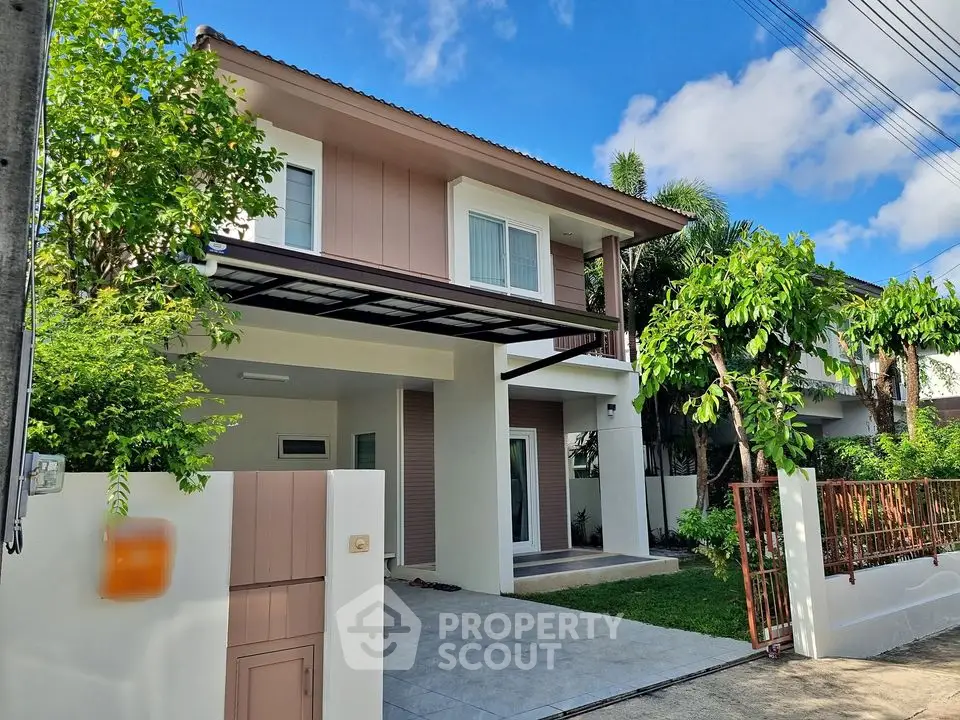 Charming two-story house with lush greenery and modern design in a serene neighborhood.