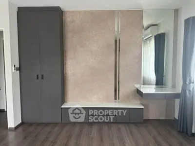 Modern bedroom with sleek built-in wardrobe and stylish vanity area.