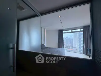 Modern bedroom with large window offering stunning cityscape view