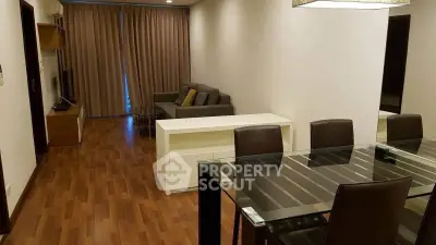 Spacious modern living room with wooden flooring and elegant dining area.
