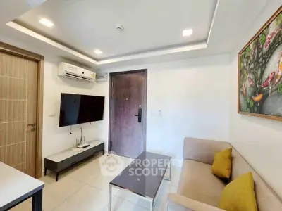 Modern living room with sleek furniture and wall-mounted TV in a stylish apartment.