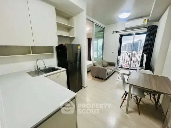 Modern apartment interior with open kitchen and city view, featuring sleek design and natural light.