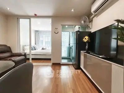 Modern living room with open layout, stylish furniture, and natural light in a cozy apartment.