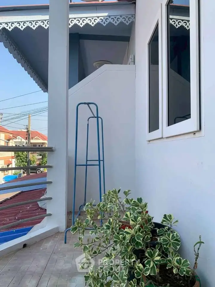 Charming balcony with decorative railing and lush greenery, perfect for relaxation and enjoying the view.