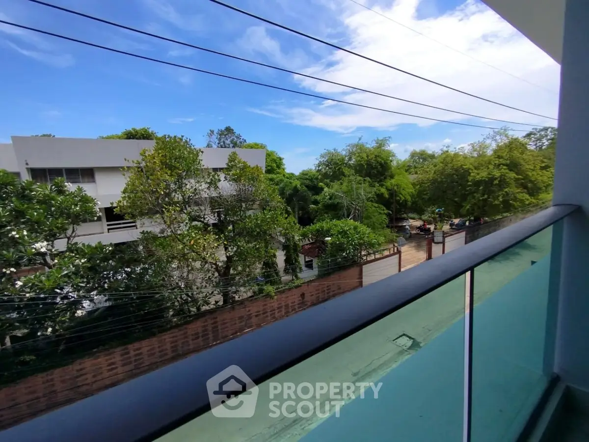 Stunning balcony view with lush greenery and modern architecture.