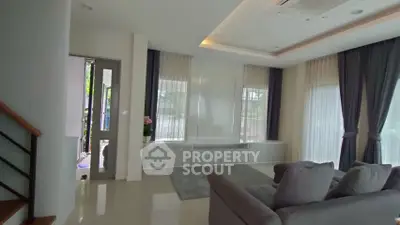 Modern living room with elegant curtains and cozy gray sofa