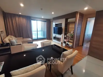 Spacious modern living room with elegant dining area and large windows for natural light.