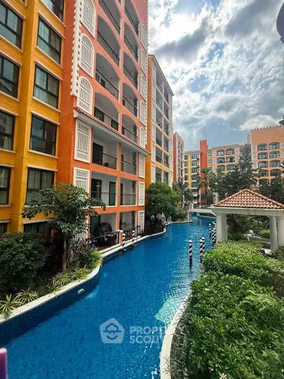 Stunning apartment complex with vibrant facade and luxurious poolside view.