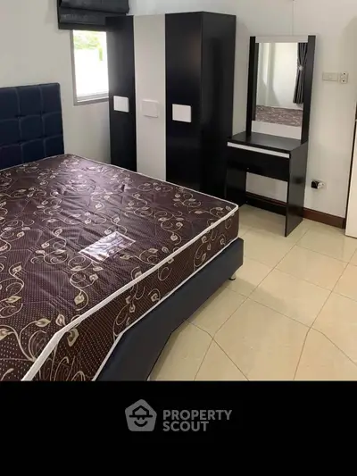 Spacious bedroom with modern furniture and large wardrobe