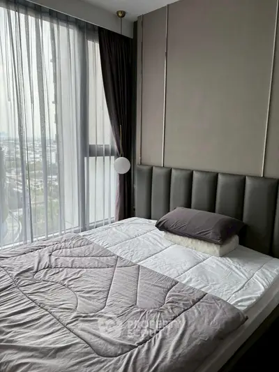 Modern bedroom with large window and stylish decor in urban apartment