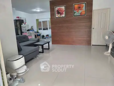 Spacious living room with modern decor and sleek furniture, perfect for family gatherings.