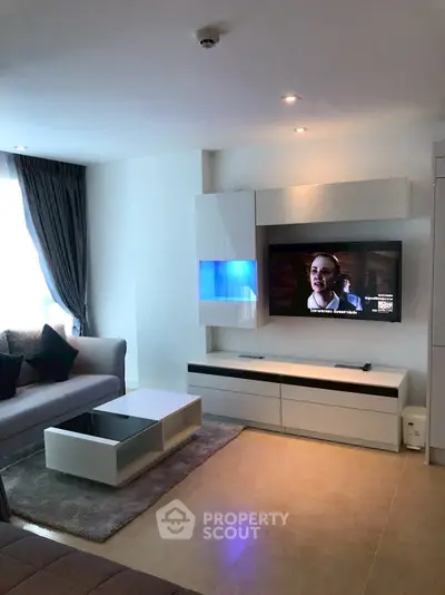 Modern living room with sleek furniture and wall-mounted TV