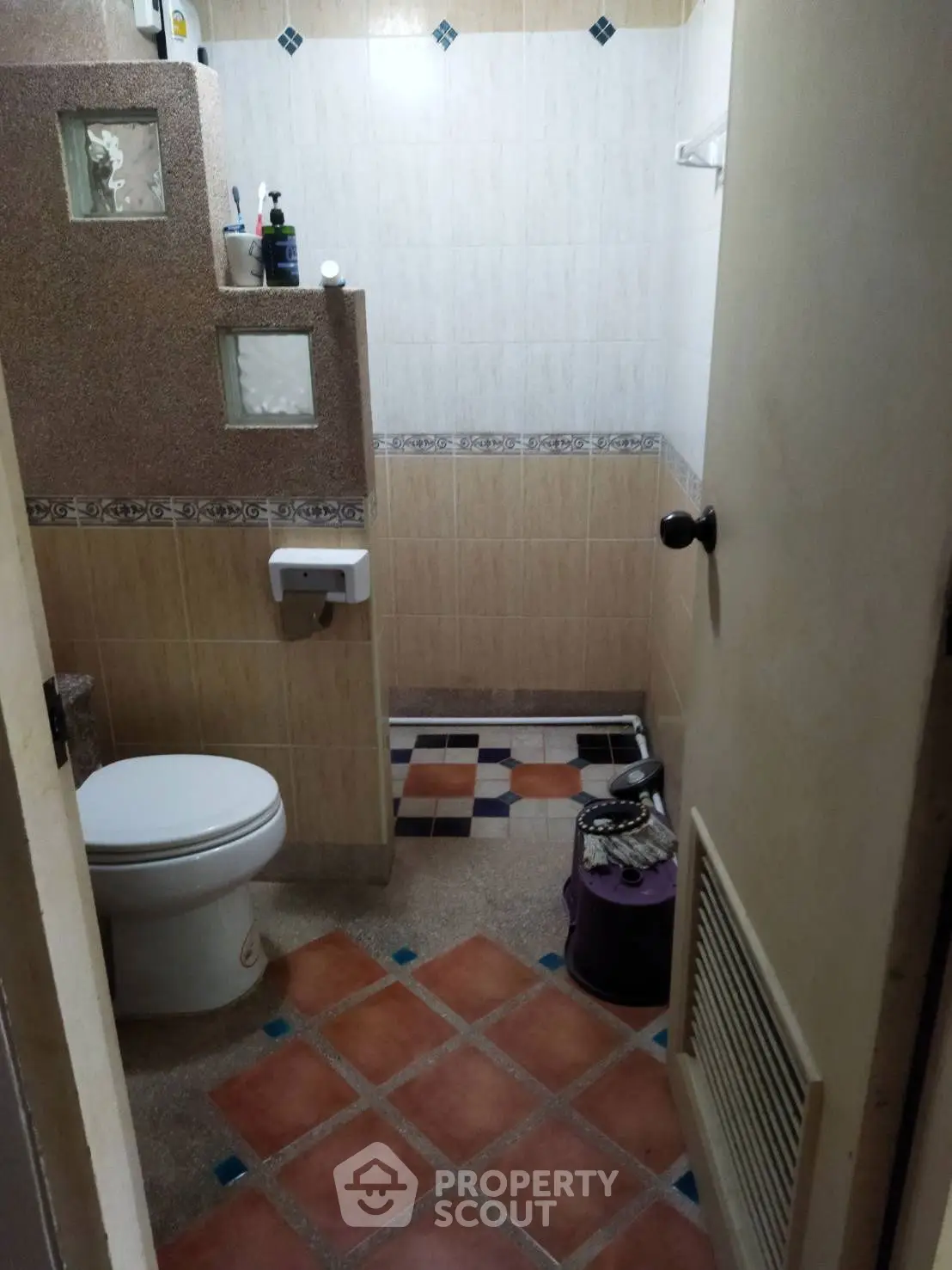 Cozy bathroom with tiled floor and modern fixtures in a charming home.