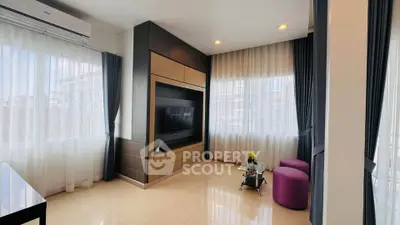 Spacious modern living room with large windows and elegant decor