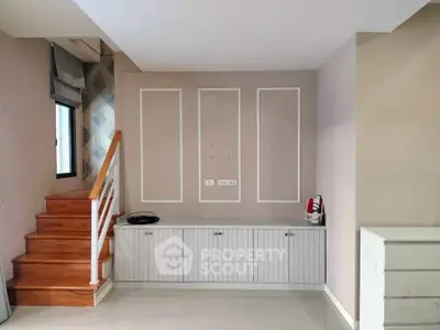 Stylish interior with wooden staircase and modern cabinetry