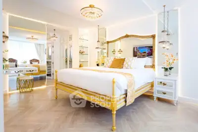 Luxurious bedroom with elegant gold accents and chic decor, featuring a spacious layout and stylish lighting.
