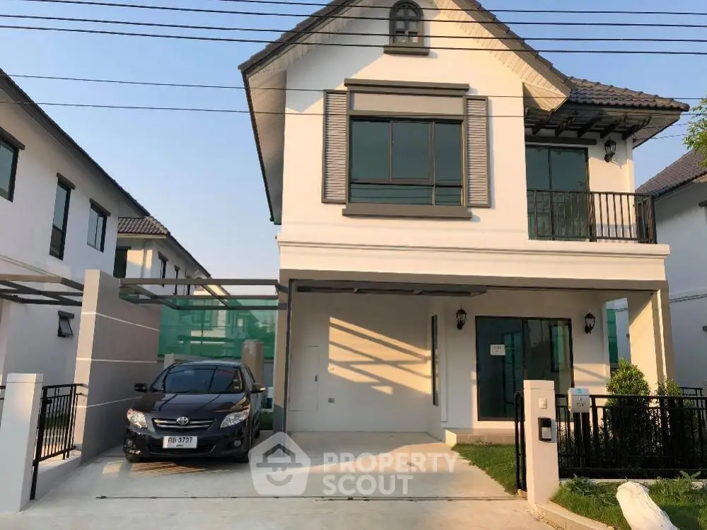 Charming two-story home with a spacious driveway and attached garage, boasting a well-maintained facade and inviting entrance, nestled in a serene neighborhood.