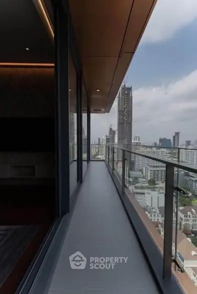 Stunning high-rise balcony with panoramic city views and modern glass railing.