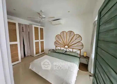 Charming bedroom with unique headboard and modern decor in a stylish home.