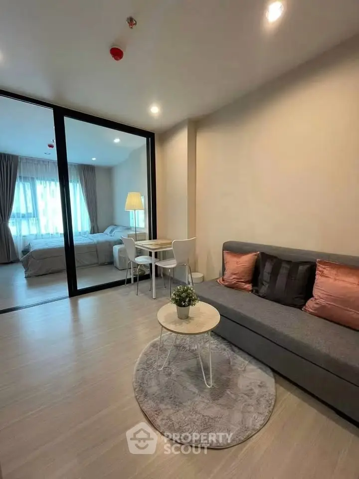 Modern living room with cozy seating and elegant decor in a stylish apartment.