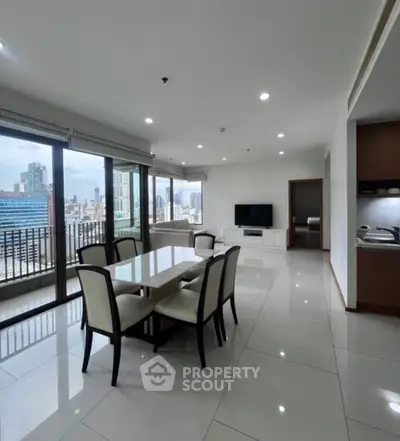 Spacious modern living room with dining area and city view balcony.