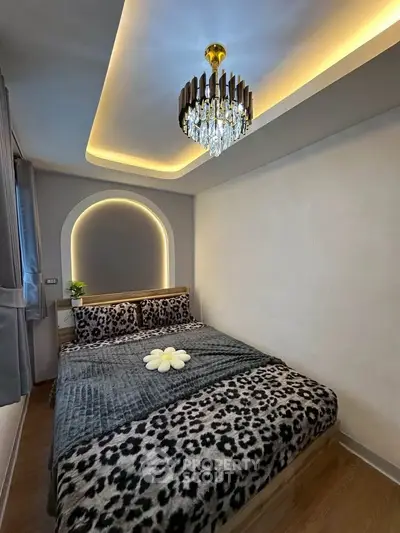 Cozy bedroom with modern lighting and stylish decor, perfect for relaxation.