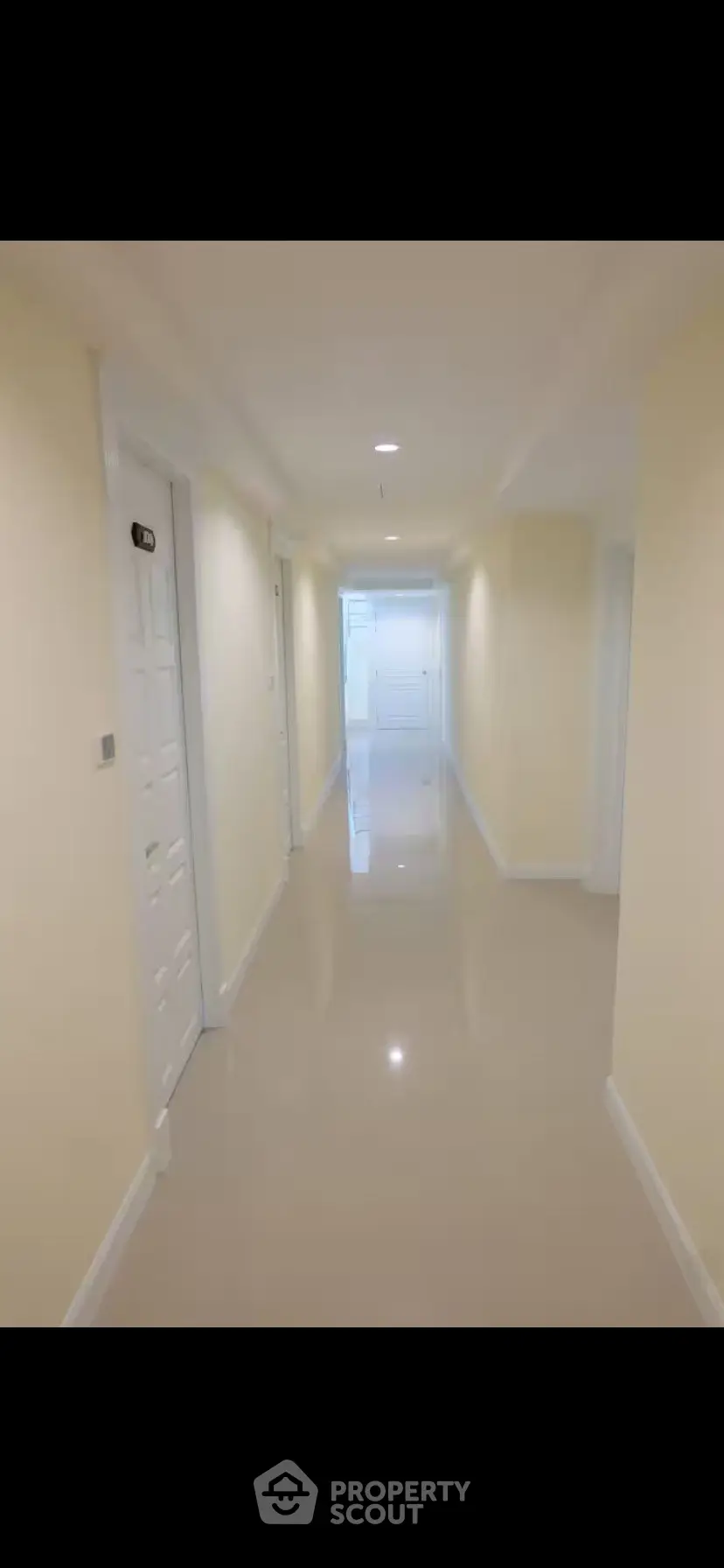 Spacious and well-lit corridor in modern apartment building