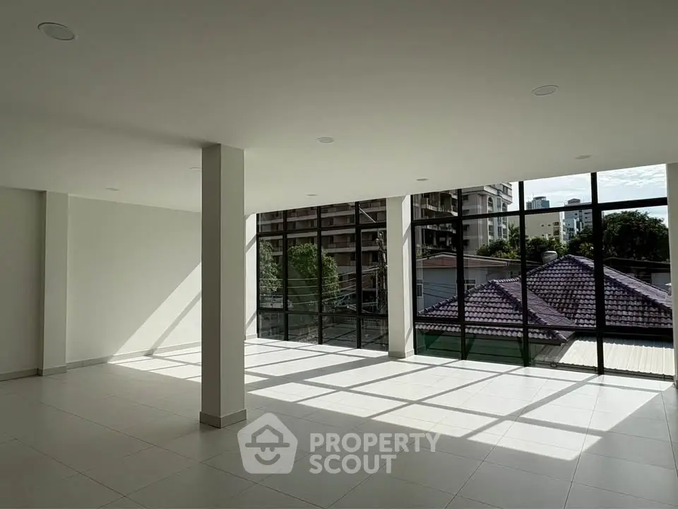 Spacious modern living room with large windows and city view