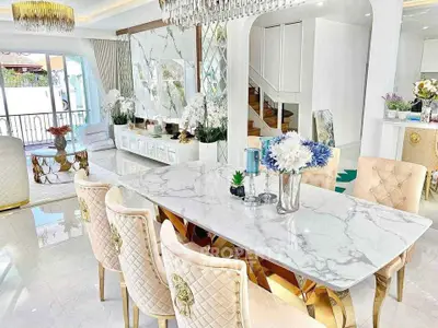 Luxurious open-plan living and dining area with elegant decor and marble finishes.