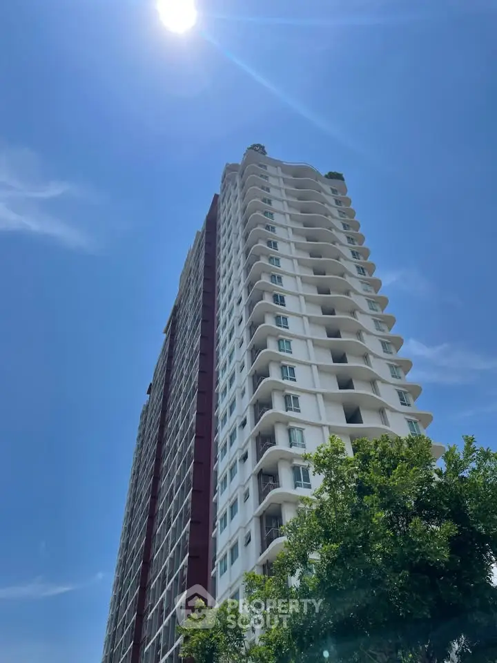 Stunning high-rise building with modern architecture under a clear blue sky.