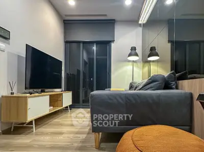 Modern living room with sleek furniture and large TV, perfect for relaxation.