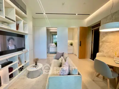 Modern living room with stylish decor and open layout, featuring a cozy sofa and wall-mounted TV.