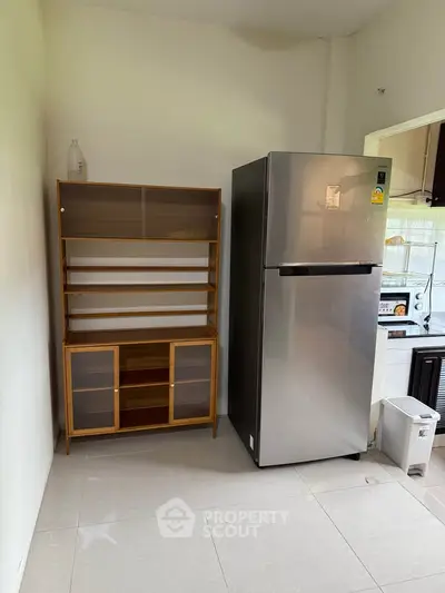 Modern kitchen with sleek fridge and stylish wooden cabinet