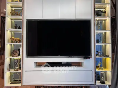 Modern living room with sleek entertainment unit and stylish decor accents.