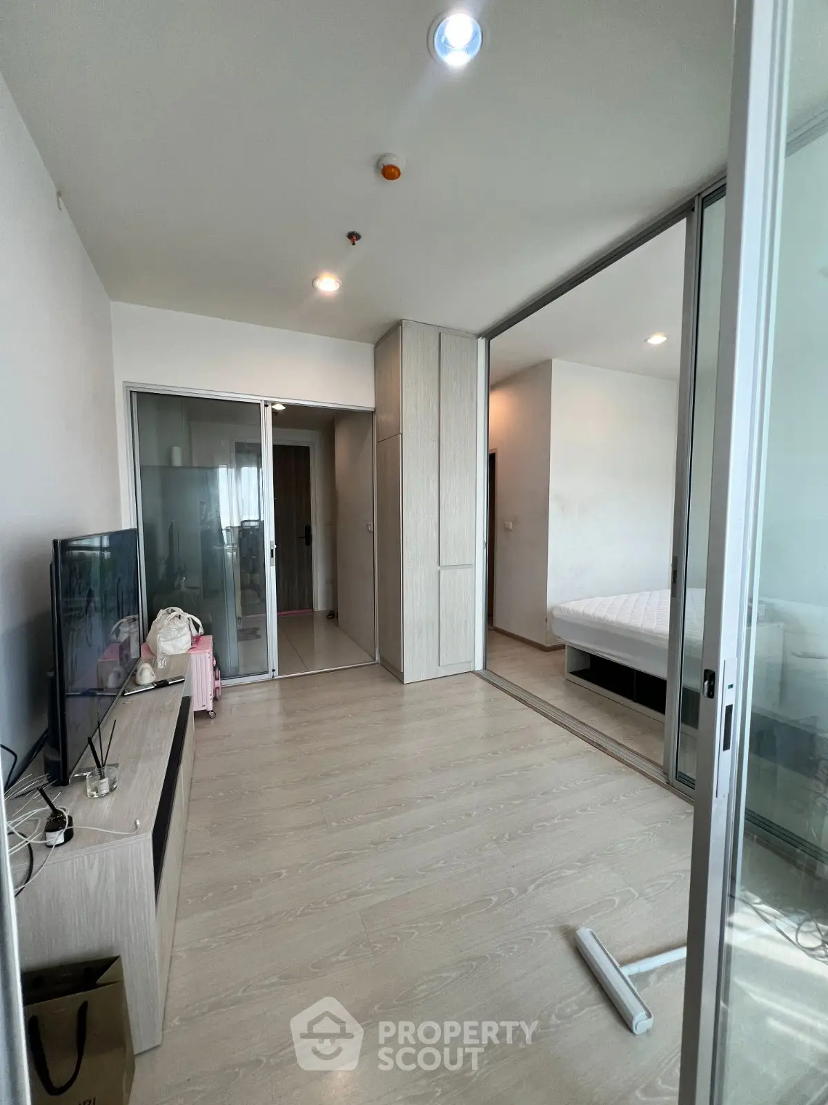 Modern apartment interior with sliding glass doors and wooden flooring