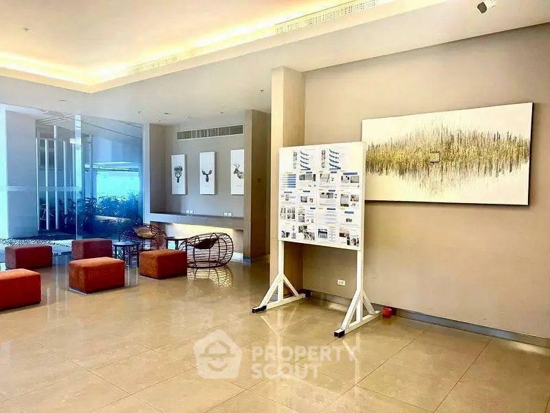 Modern lobby with stylish seating and art, perfect for welcoming guests.