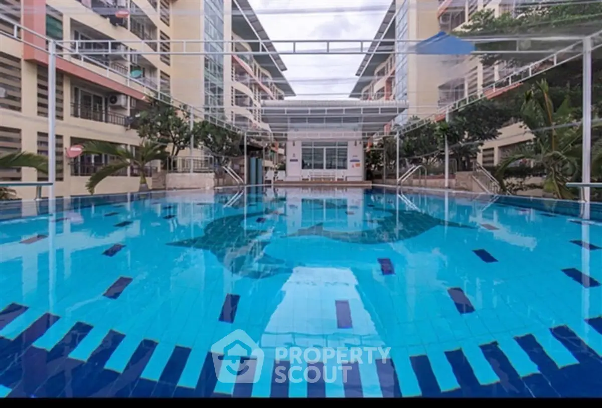 Luxurious residential complex with a stunning outdoor pool and modern architecture.