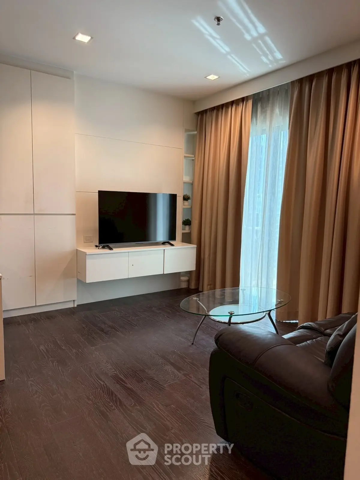 Modern living room with sleek TV setup and cozy seating area