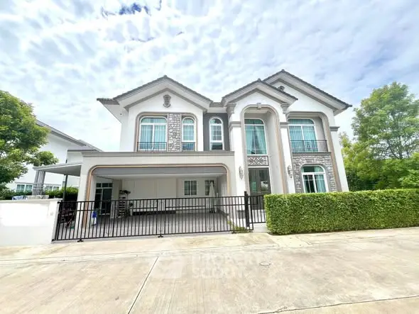 Elegant two-story house with modern architecture and lush greenery, perfect for family living.